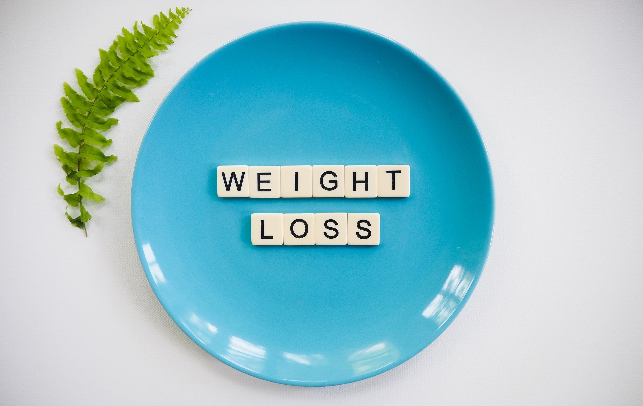 A Blue Plate With Weight Loss Written On It