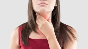 Woman Touching Her Throat In Discomfort