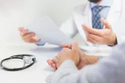 A Doctor and Patient Discussing At The Desk