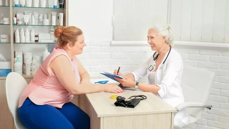 Doctor Consulting With An Obese Patient