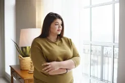 Woman Standing By Window