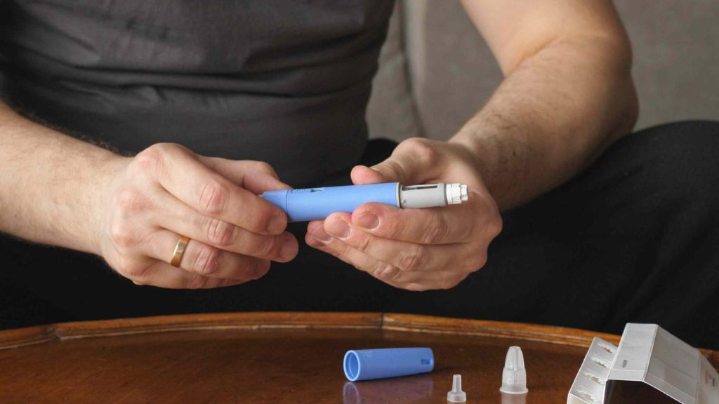 Hands Preparing Insulin Injection Pen