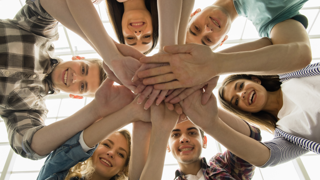 Group of Friends Joining Hands in Unity