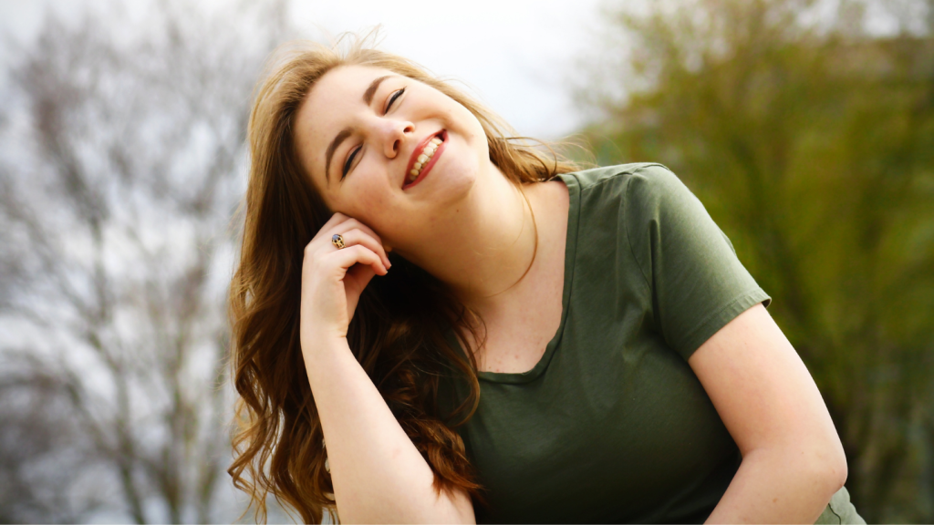 Happy Woman Relaxing Outdoors with Smile