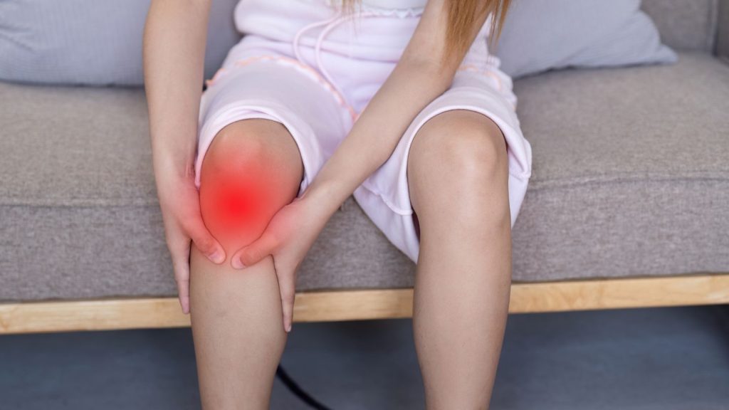 Person Holding Their Knee In Pain
