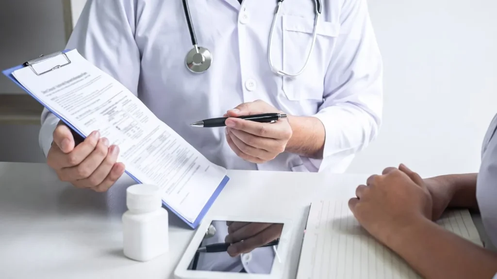 Doctor Explaining Medical Report To Patient