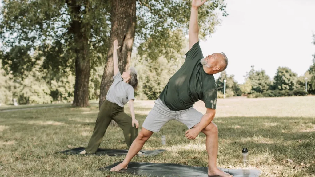 Senior Couple Practicing Yoga Outdoors